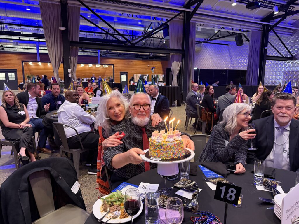 Two guests with a birthday cake
