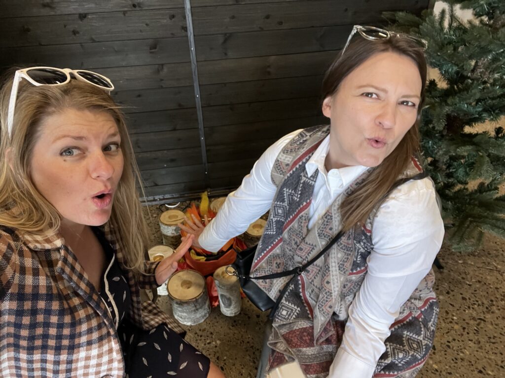 Two volunteers posing by a fake fire