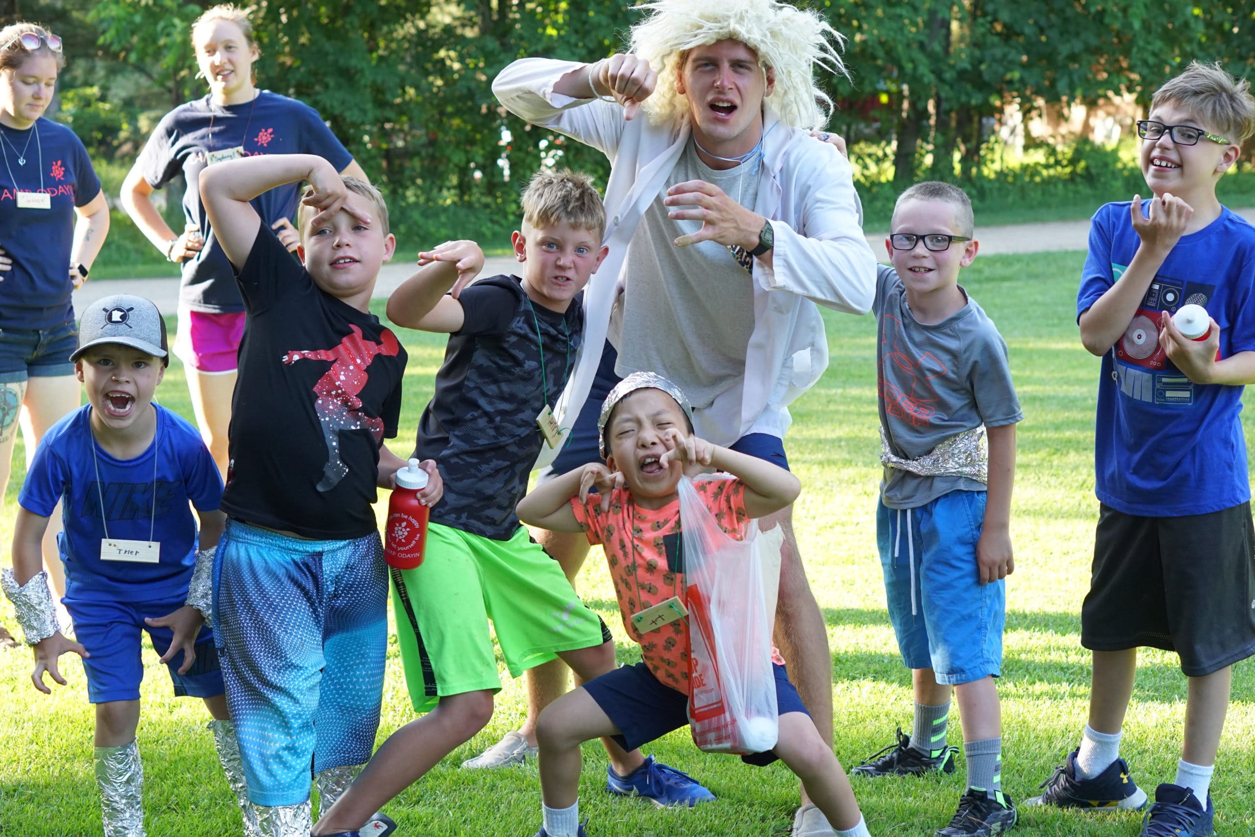 Group of campers and their cabin counselor asking super silly for the camera