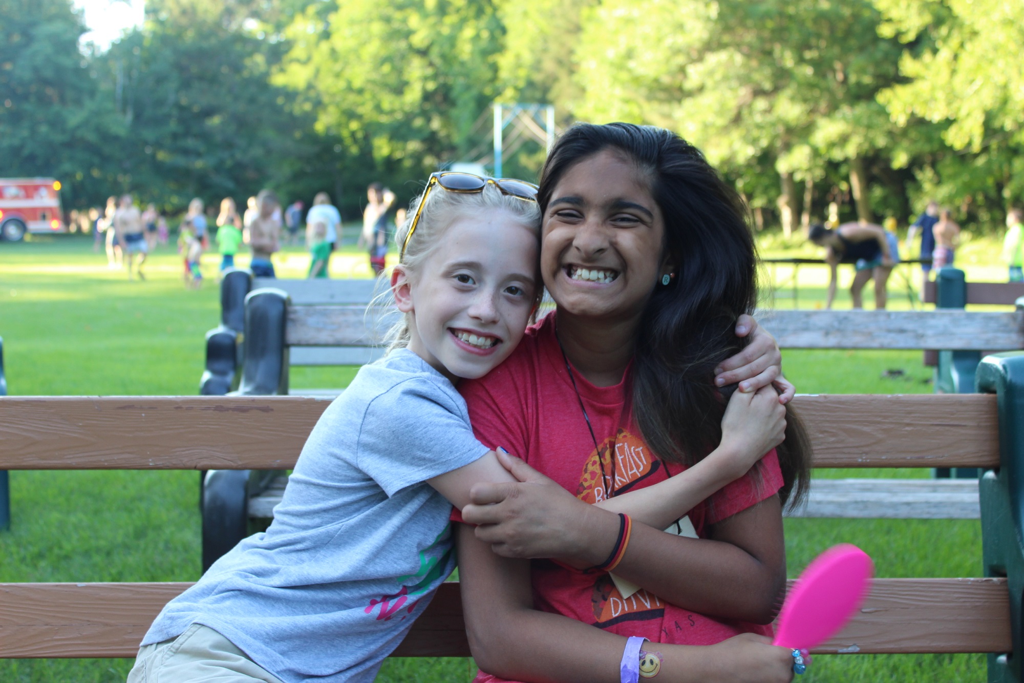 two young people smiling and hugging