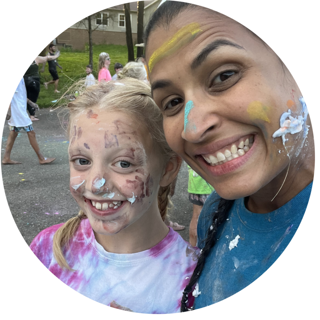 Volunteer cardiologist with a camper during Messtivus - both have chalk and shaving cream on their faces