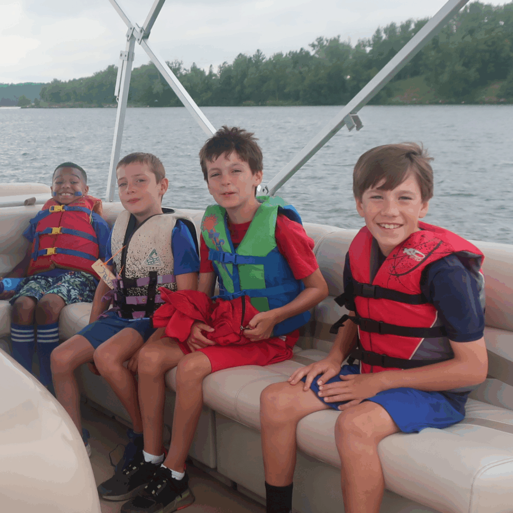 Four children on a pontoon in a lake