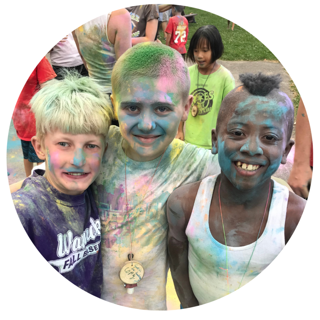 Three campers covered in colored powder