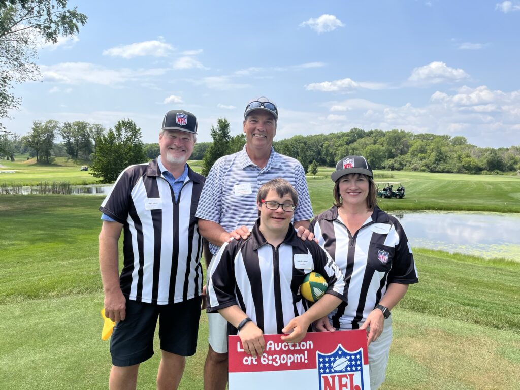 Golfer pictured with three volunteers wearing referee jerseys