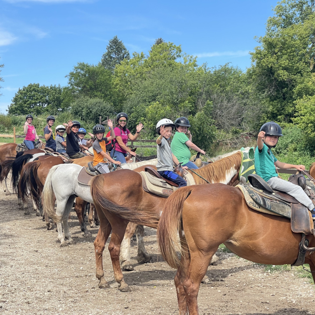 Campers and staff lined up on horseback at Residential Camp in Wisconsin