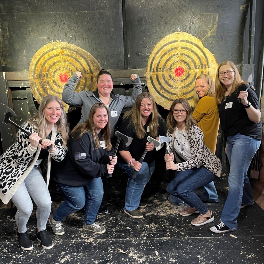 participants at the Moms Retreat posing after axe throwing in Stillwater, MN