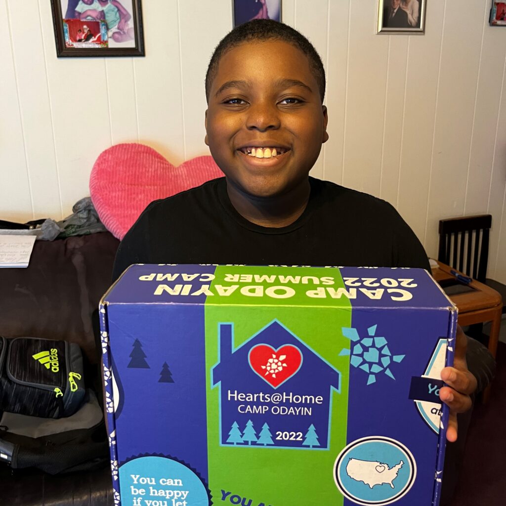 A virtual camper in Florida receiving his mailed Hearts@Home camp-in-a-box.