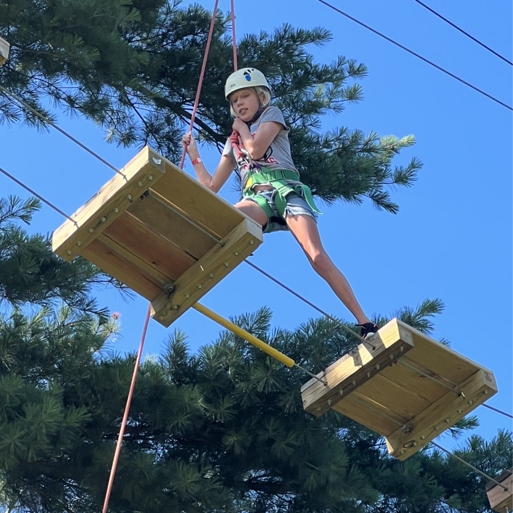 An Odayin camper braving the high ropes course at Wisconsin Residential Camp