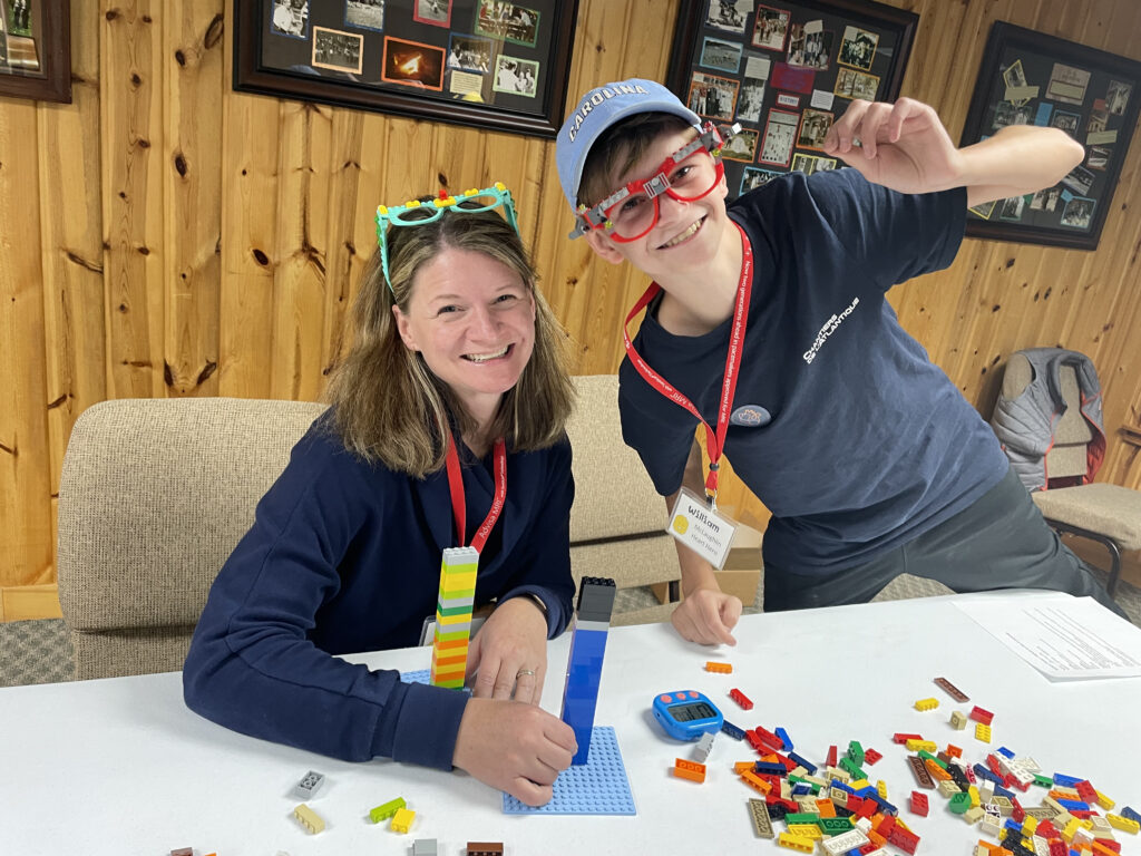 Parent and camper building with Lego at Family Camp