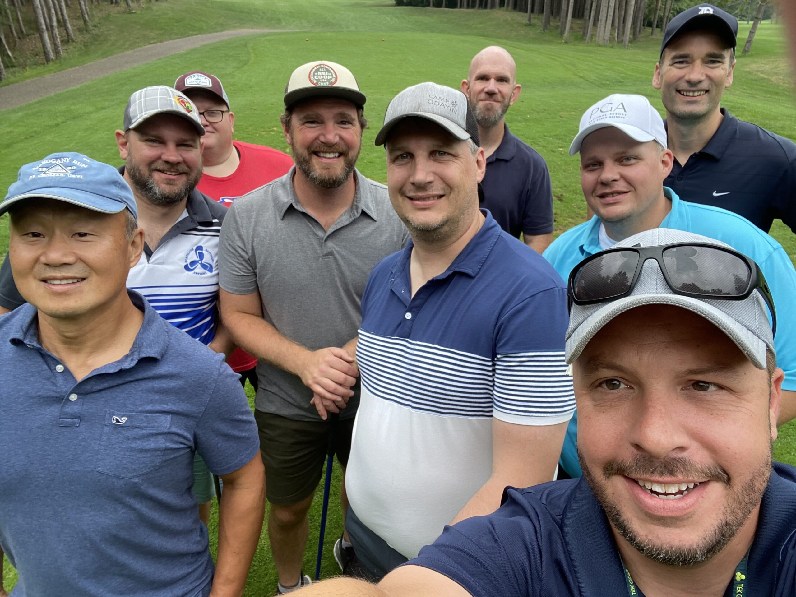 A group of Dads Day participants gathered together on a golf course