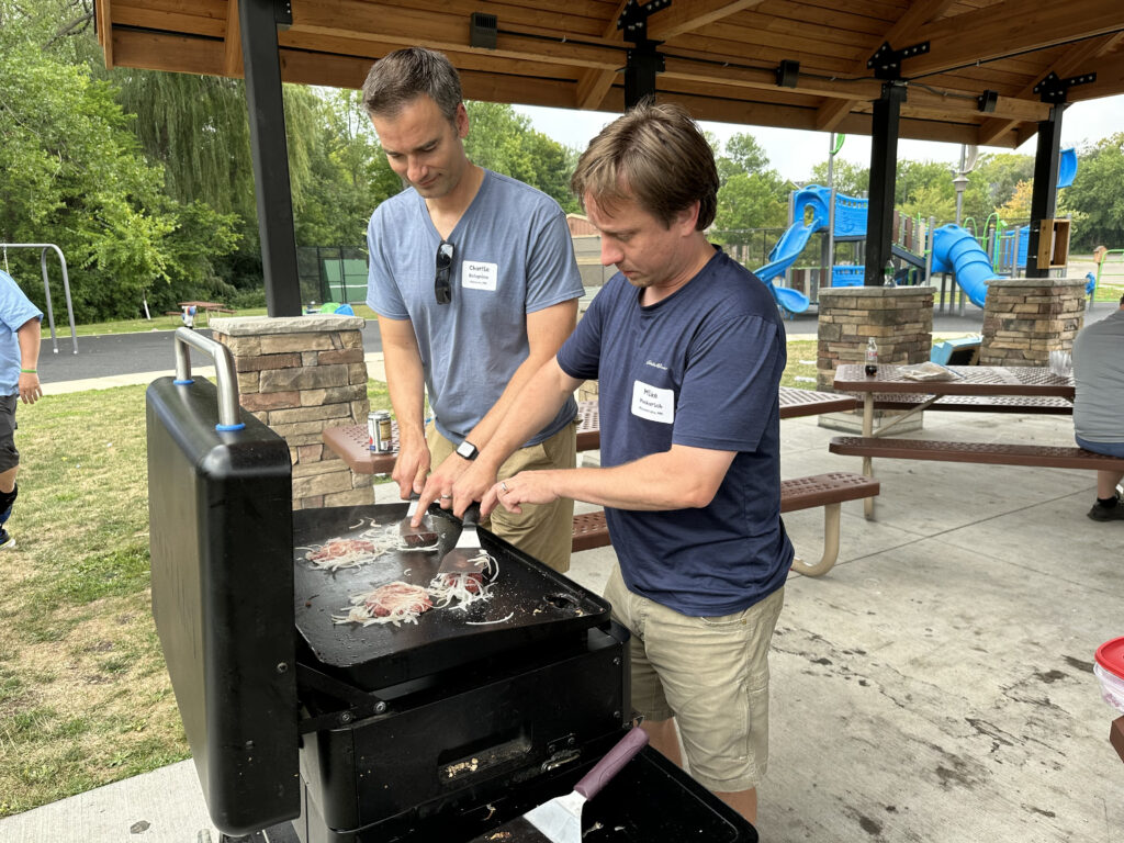 Dads Day participants grilling at an outdoor pavilion