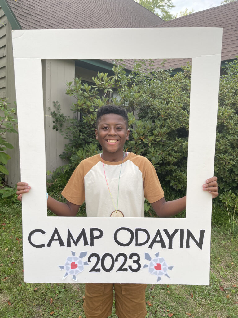 Camper holding frame stating Camp Odayin 2023