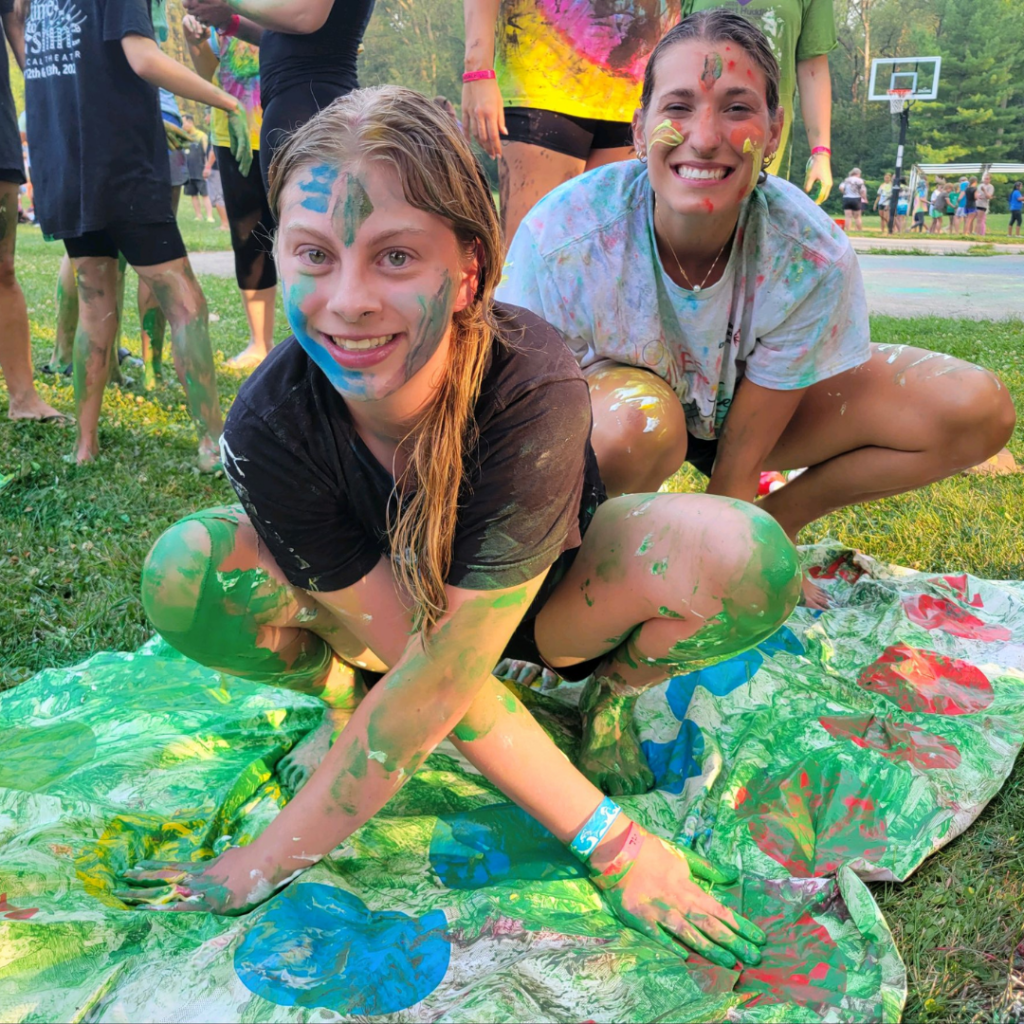 Camper and volunteer playing messy Twister