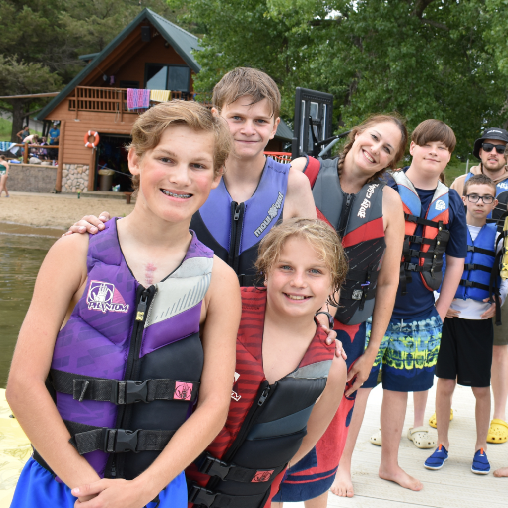 Campers in life jackets standing on a dock