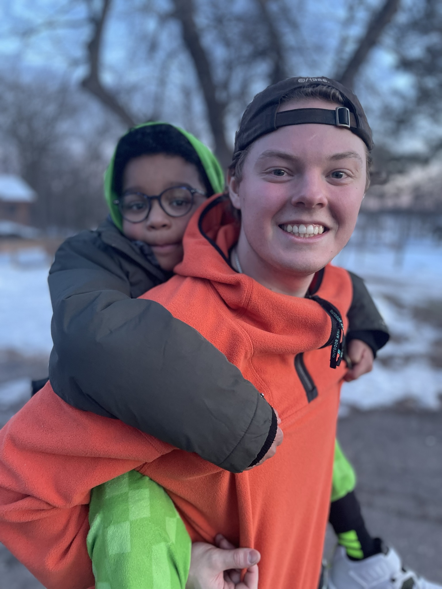 Camper receiving a piggy back ride from a staff member