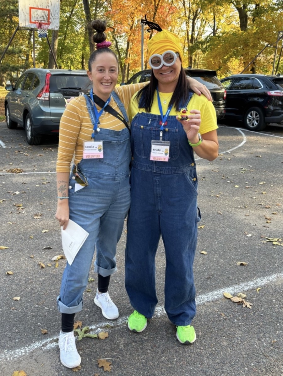 Volunteers Cassie and Kristy stand in costume together