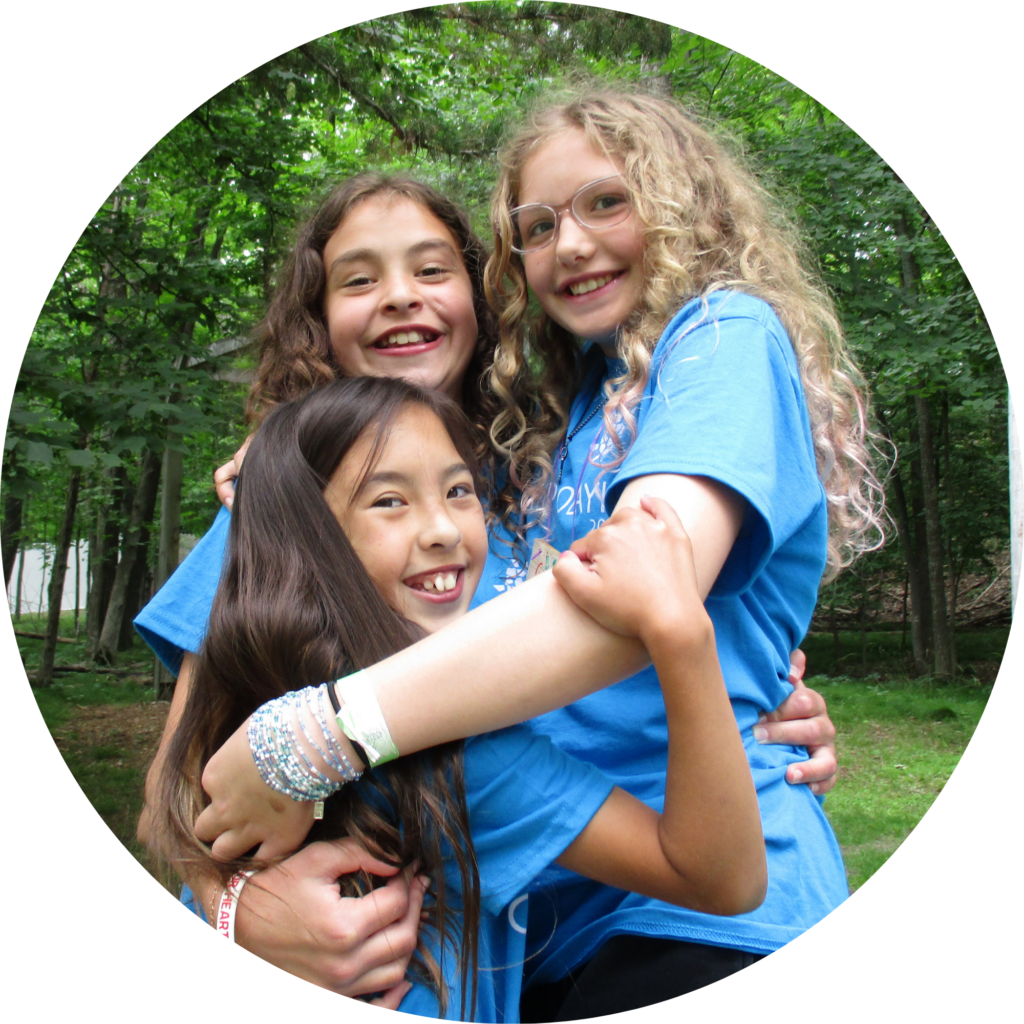 Three campers hugging