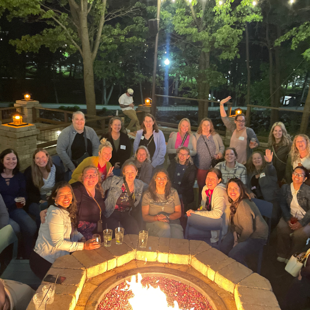 Moms retreat attendees gathered around a fire